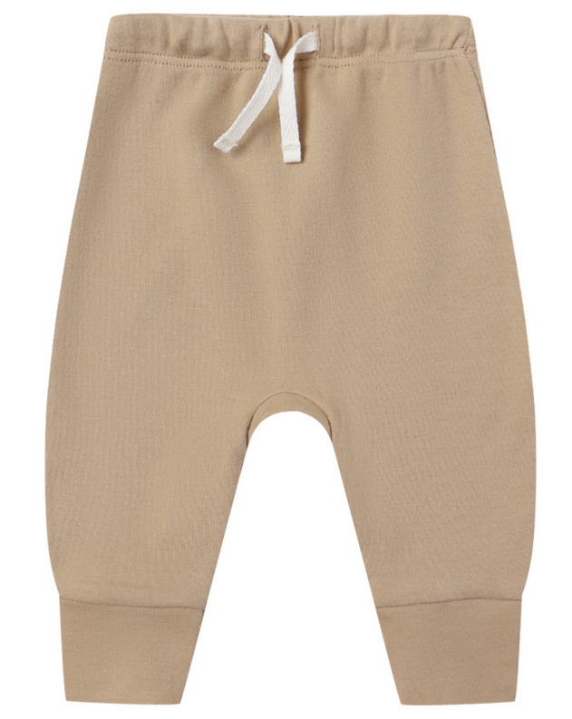 The Quincy Mae Baby Drawstring Pant in beige is made from organic brushed jersey, featuring an elastic waistband and cuffed ankles, shown against a white background.