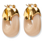 The Organic Mini Gold Hoops by Lizzie Fortunato are elegant hoop earrings made from gold-plated brass and beige accents, featuring secure gold clasps and set beautifully against a white background.