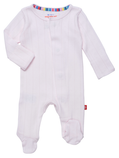 The Baby Love Lines Pointelle Footie by Magnetic Me is a pink onesie made from soft organic cotton, featuring long sleeves, foot coverings, and a multicolored striped neckline—a true baby wardrobe staple.