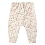 Quincy Mae Baby Drawstring Pant in cream-colored organic brushed jersey with a light pink floral pattern, elastic waistband, and fold-over cuffs shown on a white background.