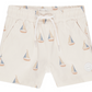 The Rylee & Cru Boys' Board Short features a beige color, elastic waistband, drawstring, and a blue and tan sailboat print—perfect for pairing with a matching swimsuit.
