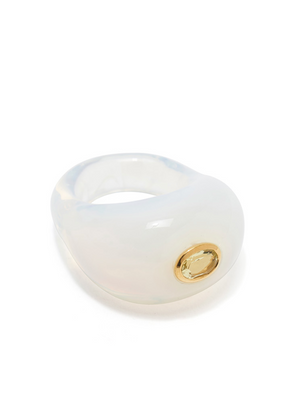 Introducing the Lizzie Fortunato Monument Ring, a stunning piece with a glossy white finish and smooth surface, akin to hand-blown glass cocktail rings. It features a gorgeous yellow gemstone set in an elegant gold bezel.