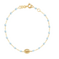 The Gigi Clozeau Madone Charm Bracelet, by Gigi Clozeau, is a 6.7" piece made of delicate 18-carat gold, featuring light blue beads and a small gold medallion for a timeless design.