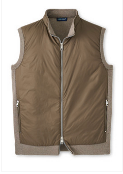 The Peter Millar Holdridge Hybrid Full-Zip Sweater Vest is a sleeveless brown vest with two zippered side pockets, light beige trim, and performance fabric for high wind and water resistance.