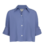 The TWP Next Ex Stripe Shirt is a cropped blue button-down with a boxy silhouette, short sleeves, collar, and front chest pocket.