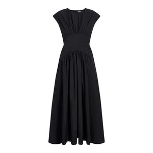 The Nyssa Dress by Proenza Schouler White Label is a long black dress featuring a gathered bodice, fitted waist, and flared A-line skirt, shown against a white background.