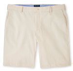 A pair of Peter Millar men's light-colored, water-resistant Surge Performance Shorts with a button closure and visible waistband laid flat against a white background.