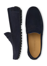 Top view of a pair of navy blue Peter Millar Suffolk Suede Driver loafers with black pebbled rubber outsoles.