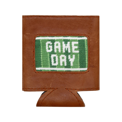 The Smathers & Branson Game Day Can Cooler features brown leather and a green and white stitched patch reading "GAME DAY" on the front. Blending timeless style with practical design, this can cooler keeps your beverage cold while bringing a sporty flair to any event.