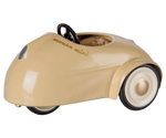 Beige, vintage-style “Car, Mouse - Wheat” by Maileg, featuring white wheels, a black steering wheel, and photographed on a plain white background.