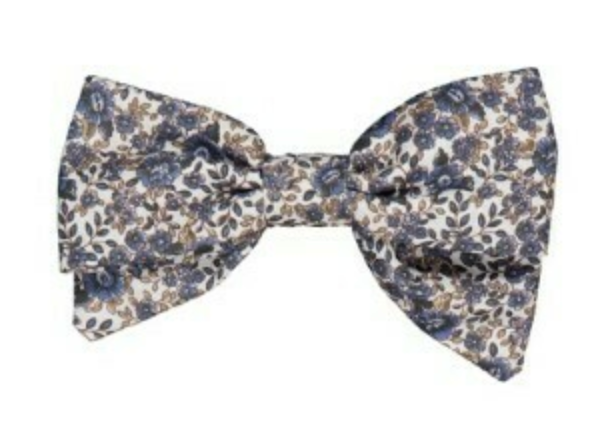 The Kidiwi Bonnie Embroidered Hair Clip features a large bow with blue and brown floral embroidery on white, making it a stylish hair accessory.