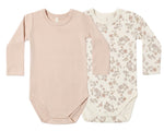 The Quincy Mae Baby Jersey Bodysuit 2-Pack features two long-sleeve one-piece bodysuits—one in solid light pink and the other in cream adorned with a pink and brown floral pattern. Made from soft brushed jersey with convenient snap closures at the bottom, these organic baby onesies offer everyday comfort.