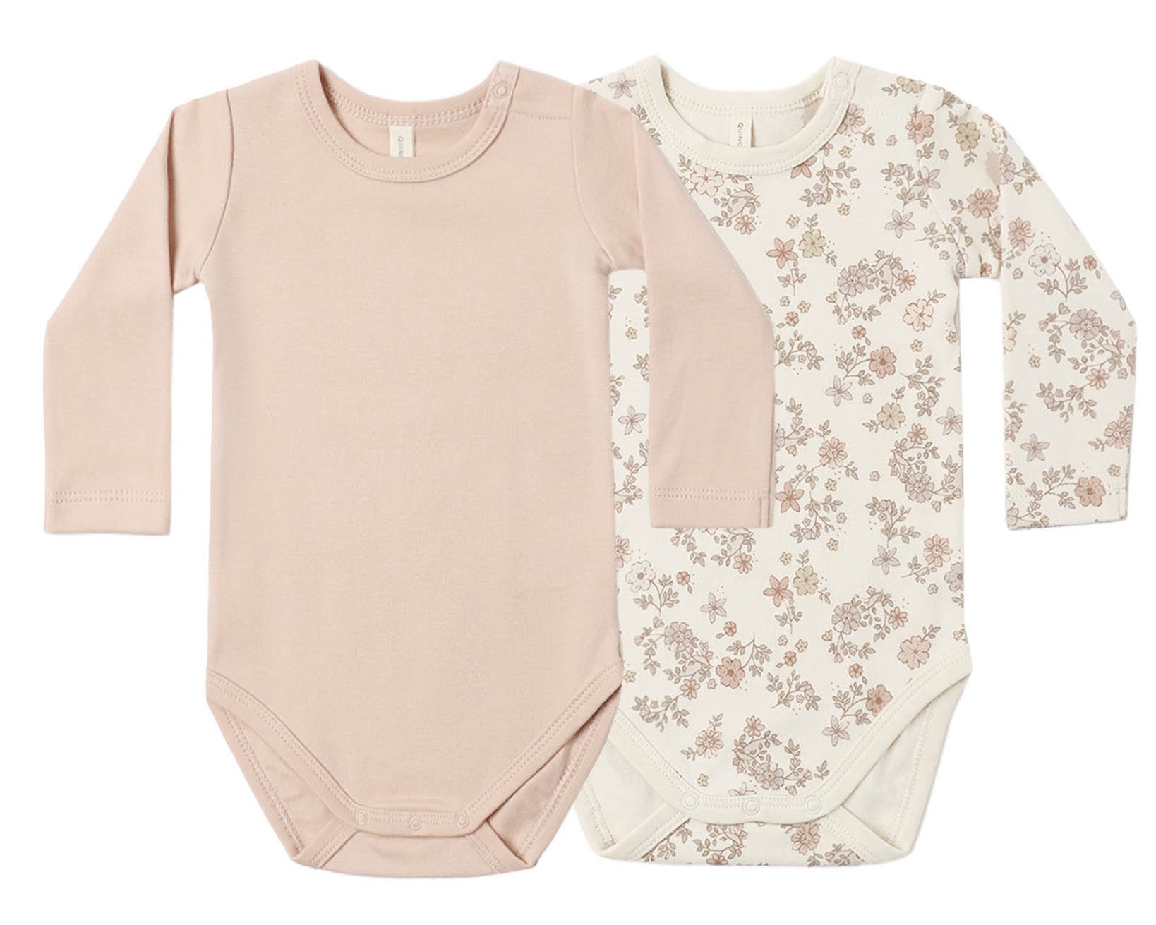 The Quincy Mae Baby Jersey Bodysuit 2-Pack features two long-sleeve one-piece bodysuits—one in solid light pink and the other in cream adorned with a pink and brown floral pattern. Made from soft brushed jersey with convenient snap closures at the bottom, these organic baby onesies offer everyday comfort.