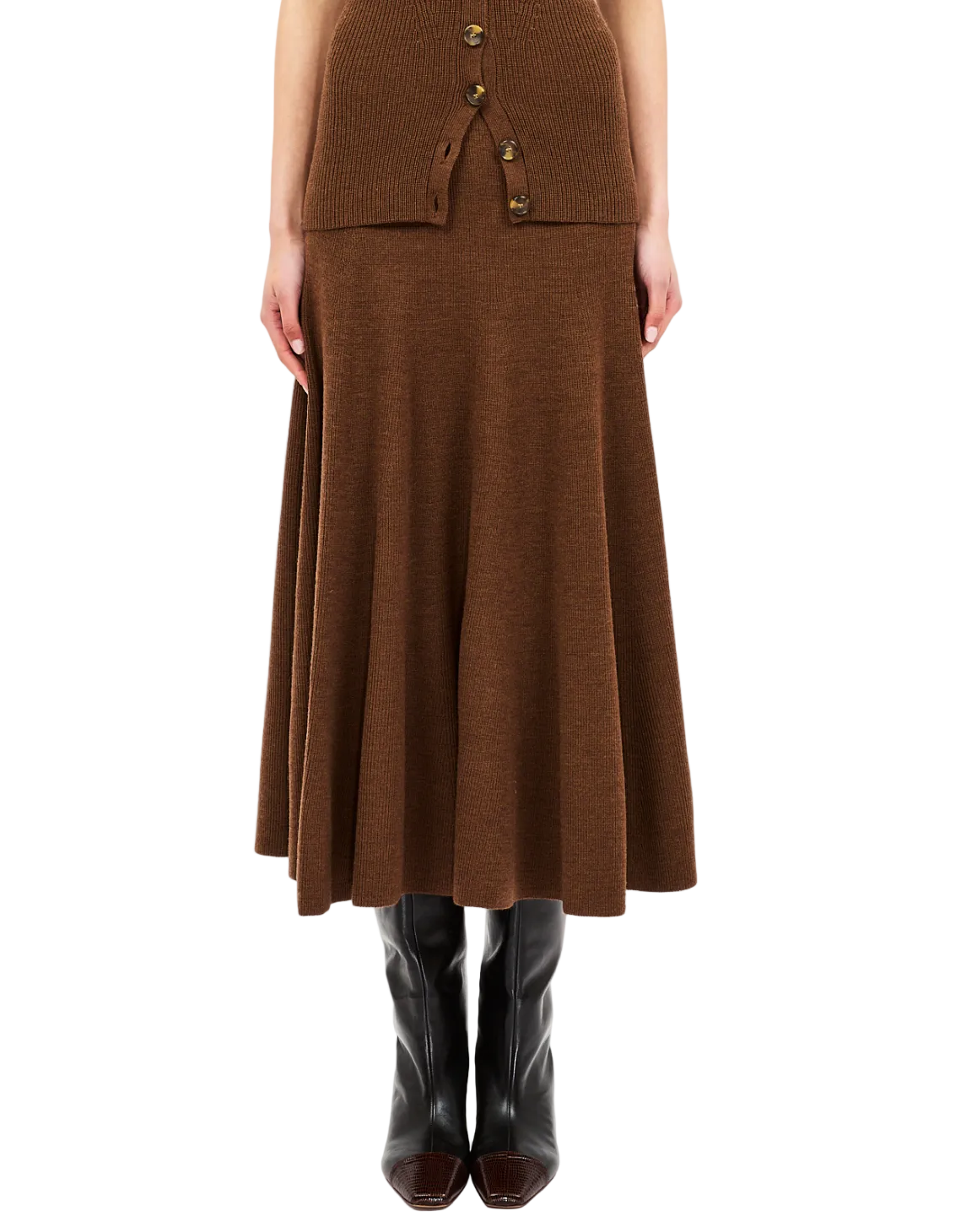 A person wearing the Ulla Johnson Azaria Knit Skirt in brown merino wool, styled with a coordinating buttoned top and black knee-high boots, shown from shoulders down.