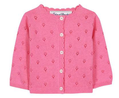 The Tartine et Chocolat Baby Girls’ and Girls’ Openwork Cardigan is crafted in a soft pink knit with a delicate eyelet pattern, long sleeves, classic white buttons down the front, and a charming ruffled neckline—an ideal layering piece for any occasion.