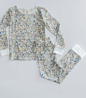 Timo & Violet's Kids' The Two Piece Pajamas, made from organic cotton, feature a colorful woodland animal and plant print and are displayed laid flat on a white background.