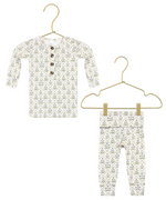 Lou Lou & Company’s Baby Girls’ and Girls’ Etta Top & Bottoms set, featuring a silky-soft long-sleeve buttoned top and matching leggings adorned with a green and gray leaf pattern, is displayed on gold hangers against a white background.