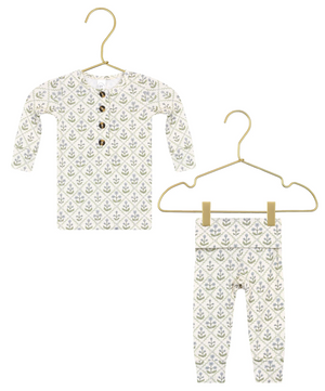 Lou Lou & Company’s Baby Girls’ and Girls’ Etta Top & Bottoms set, featuring a silky-soft long-sleeve buttoned top and matching leggings adorned with a green and gray leaf pattern, is displayed on gold hangers against a white background.