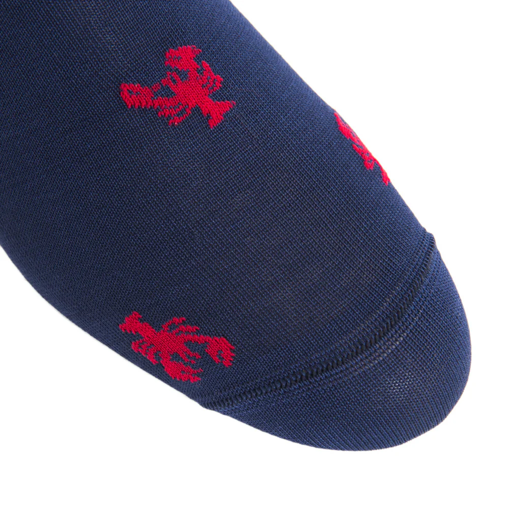 Close-up of the Dapper Classics Red Lobster Cotton Mid-Calf Sock in navy blue, showcasing small red lobster motifs and crafted from breathable, comfortable cotton.
