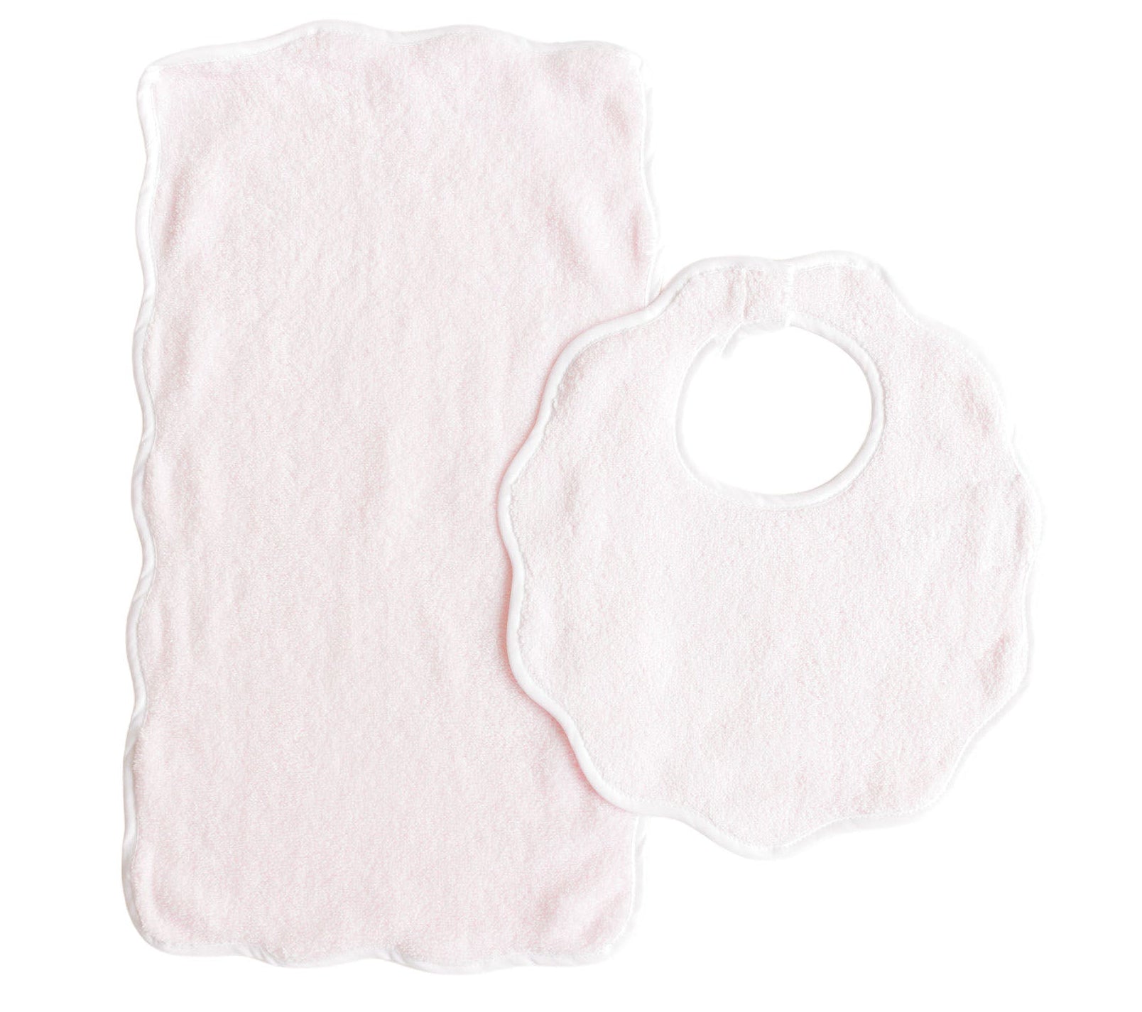 The Terry Tots Bib & Burp Set, featuring a light pink scalloped-edge bib and matching burp cloth, is displayed flat on a white background—an adorable way to add charm to everyday feeding moments.