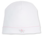 The Kissy Kissy Baby SCE Jungle Hang Out Hat is a white infant hat crafted from soft Peruvian cotton, featuring a pink-trimmed edge and a hand-embroidered gray elephant with a pink ear on the front.