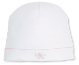 The Kissy Kissy Baby SCE Jungle Hang Out Hat is a white infant hat crafted from soft Peruvian cotton, featuring a pink-trimmed edge and a hand-embroidered gray elephant with a pink ear on the front.