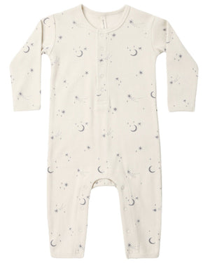 The Quincy Mae Baby Ribbed Jumpsuit is a long-sleeve, cream-colored piece with a slim-fit rib knit design, decorated with an adorable pattern of tiny moons, stars, and dots. It features front buttons and convenient snaps at the legs for easy changes.