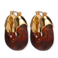 The Lizzie Fortunato Organic Gold Hoops feature chunky, translucent brown resin hoops and gold-tone metal tops, shown against a white background.