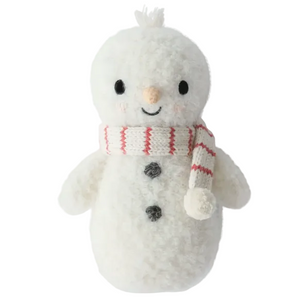 The Baby Snowman - Candy Cane by Cuddle + Kind is a plush toy handcrafted from soft baby companion cotton yarn, featuring stitched black eyes, a smiling mouth, a carrot-shaped nose, black buttons, and a white scarf with red stripes for heirloom-quality charm.