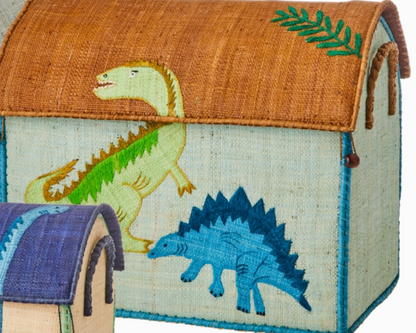 The Rice Raffia Toy Basket features a green dinosaur on the lid and a blue stegosaurus on the side, adding playful charm. A smaller matching basket is partially visible, perfect for fun and practical storage.