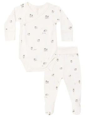 The Quincy Mae Baby Side Snap Bodysuit + Pant Set includes a white long-sleeve side snap bodysuit and coordinating footed pants, both decorated with a subtle light grey animal print.