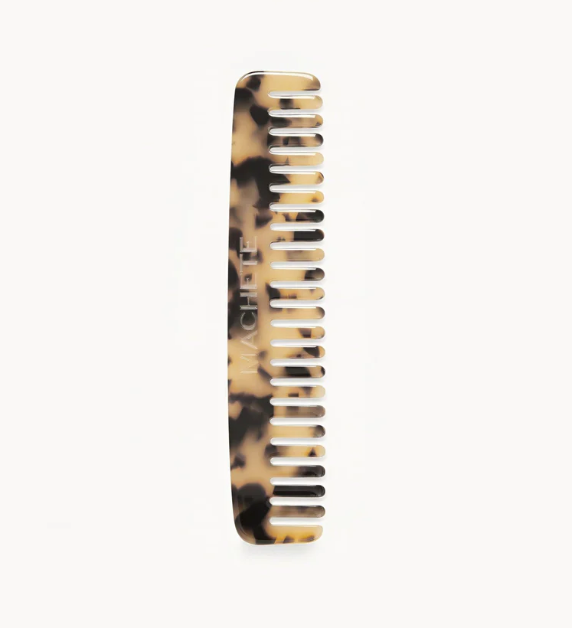 The Machete Comb No. 3, a tortoiseshell-patterned wide-tooth comb made from Italian bio-acetate and engraved with the brand name, is displayed against a plain white background.