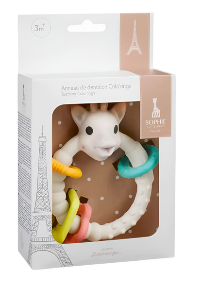 The Teething Colo' Rings by Sophie la Girafe feature a charming giraffe and colorful rings made from natural rubber for ages 3 months and up. The packaging includes an Eiffel Tower illustration to capture babies' eyes with vibrant colors and playful shapes.