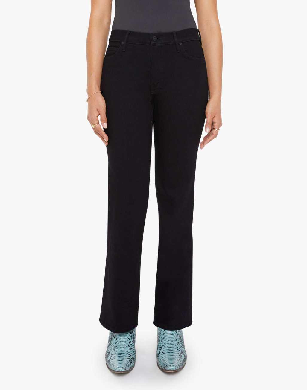 A person in Mother’s Lil Kick It black straight-leg petite jeans, a dark top, and blue snakeskin-patterned boots stands against a plain white background.