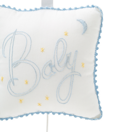 Introducing the Kissy Kissy Blue "Baby" Musical Pillow by Kissy Kissy, a charming gift featuring blue embroidery that spells out "Baby," surrounded by yellow stars and a crescent moon. This delightful white pillow is accented with a blue lace trim and comes nestled in a tulle bag, making it an ideal present for any baby occasion.