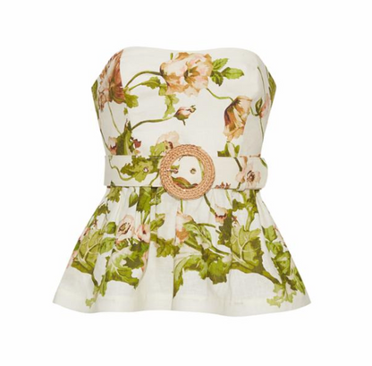 The Cara Cara Tilda Top is a strapless peplum style featuring a floral print and sweetheart neckline, finished with a wide raffia belt with a round woven buckle, shown against a white background.