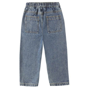 The Rylee & Cru Baby Girls' and Girls' Baggy Pant features blue denim, an elastic waistband, and two back pockets. Shown laid flat with the back side up, these pants offer a relaxed silhouette for everyday comfort.