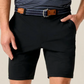 A person wearing Johnnie-O Fusionn Shorts, paired with a striped belt and a striped shirt, with one hand in their pocket.
