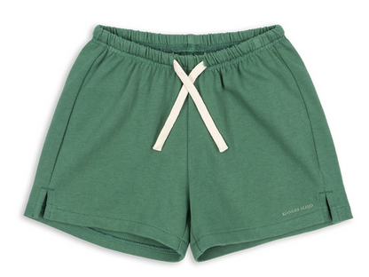 The Konges Slojd Baby Boys’ and Boys’ Spotty Sweat Short in green features a soft fabric, elastic waistband with adjustable drawstring, and small side slits, displayed on a white background.