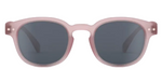 Front view of IZIPIZI Kids’ #C Polarized Sunglasses, showing matte light pink frames and dark lenses with an ergonomic design for comfort and reliable UV protection, displayed on a white background.