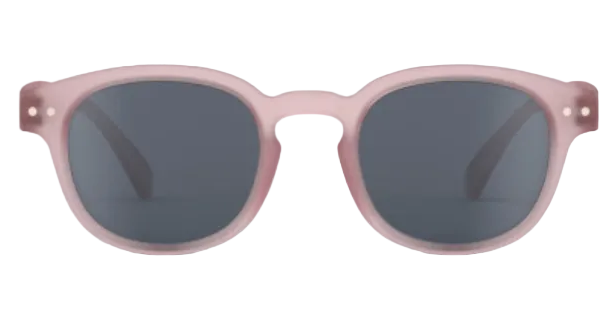 Front view of IZIPIZI Kids’ #C Polarized Sunglasses, showing matte light pink frames and dark lenses with an ergonomic design for comfort and reliable UV protection, displayed on a white background.
