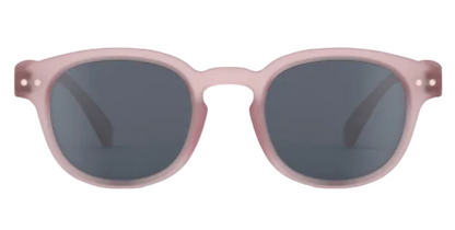 Front view of IZIPIZI Kids’ #C Polarized Sunglasses, showing matte light pink frames and dark lenses with an ergonomic design for comfort and reliable UV protection, displayed on a white background.