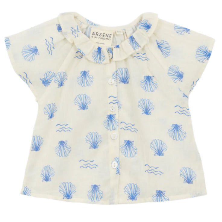 The Arsene & Les Pipelettes Baby Girls' Felixia Top is a white short-sleeve blouse with a blue shell and wave print, ruffled collar, and front buttons.