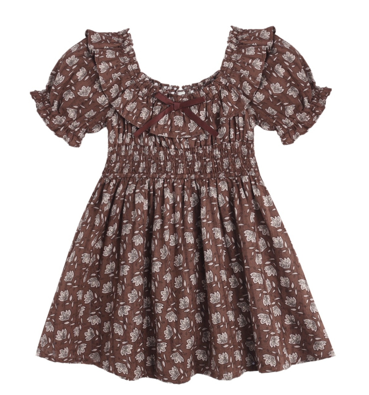 The Girls’ Dillion Dress by Rylee & Cru features a brown fabric with a white floral print, short puff sleeves, a ruffle neckline, smocked bodice, and is accented with a small maroon bow at the neckline.