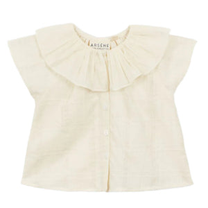 The Arsene & Les Pipelettes Baby Girls' Flava Top is a cream cotton blouse with short sleeves, a wide ruffled collar, and button-down front, shown against a white background.