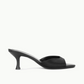 The Brigitte Satin Mule by Staud is a black open-toe mule with a kitten heel, shown in side profile against a plain white background—ideal for versatile styling.