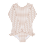 The Minnow Girls' Rashguard One Piece, a long-sleeve beige and white gingham-patterned swimsuit with ruffled leg openings and a sun-safe design, is laid flat on a white background.