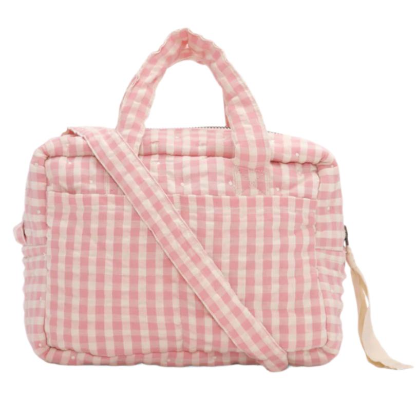 The Konges Slojd Doll Bag by Konges Slojd is a pink and white checkered quilted bag made from 100% cotton, featuring a pair of handles and an adjustable shoulder strap.