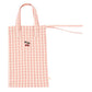 The Konges Slojd Doll Nursery Set by Konges Slojd includes a charming tote bag made from 100% cotton with a pink and white checkered pattern, two small handles, and an embroidered cherry design in the center.