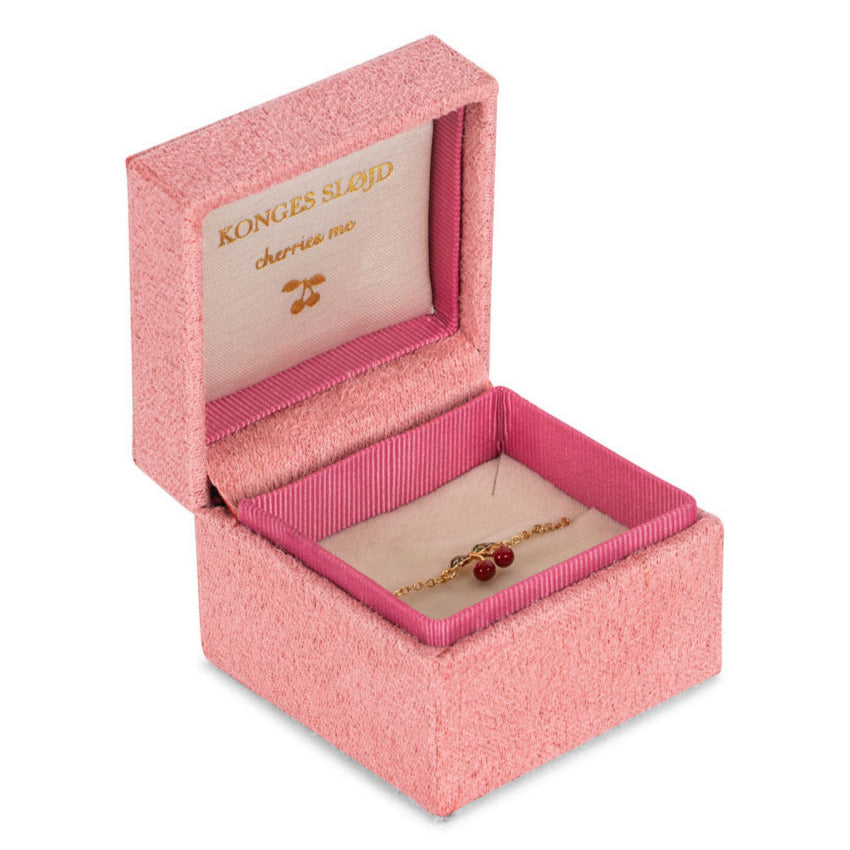 A velvet jewelry box cradles the Konges Slojd 24K Gold Plating Cherry Bracelet, featuring cherry charms and a plush interior. Labeled "Konges Sløjd" and "cheries me," it's an elegant gift for special occasions.